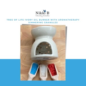 May include: White ceramic oil burner with a round opening and a textured surface. Three small wooden scoops with blue, white, and red granules are in front of the burner.