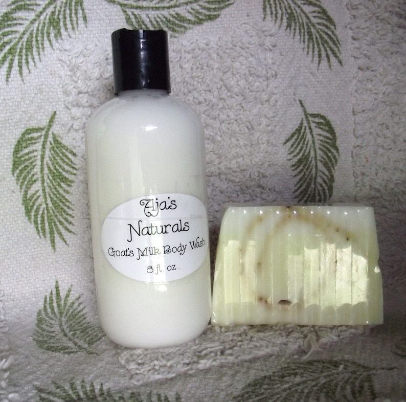 May include: A white bottle of goat's milk body wash with a white label that says "Aja's Naturals Goat's Milk Body Wash 8 fl. oz." and a bar of green soap.