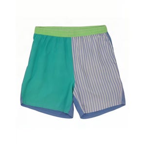 May include: Athletic shorts featuring a color-blocked design with a solid teal left panel and a light blue and white vertical striped right panel. The garment includes a lime green elastic waistband and a solid blue hem along the bottom edge.