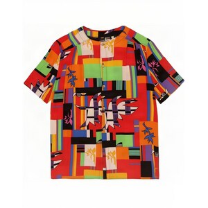 May include: A short-sleeve button-down shirt featuring a vibrant, multi-coloured geometric pattern in shades of red, orange, yellow, green, blue, and black. The design includes abstract bird-like shapes and rectangular blocks across the fabric.