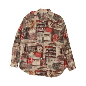 May include: A long-sleeved button-down shirt featuring a multi-coloured abstract print in shades of red, brown, and cream. The garment has a classic collar, a full-length front button placket with white buttons, and buttoned cuffs on the sleeves.