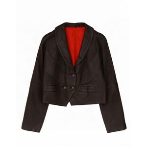 May include: A dark brown leather jacket featuring a wide shawl collar, long sleeves, and a vibrant red interior lining. The front of the jacket is secured with two buttons and includes two horizontal slit pockets positioned at the waistline.
