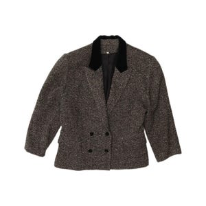 May include: A double-breasted blazer featuring a dark brown and black herringbone pattern. The garment includes a solid black velvet collar, long sleeves, two side pockets, and four black buttons arranged in a two-by-two formation on the front.