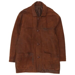 May include: A brown suede jacket featuring a classic collar, a front button closure with four matching buttons, and two large patch pockets at the lower front. The garment has long sleeves with cuffs and a visible dark brown interior lining.