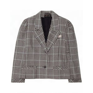 May include: A black and white houndstooth blazer featuring a notched lapel, long sleeves, and a single button closure. The garment includes two front flap pockets and a black interior lining with a visible brand label at the neck.