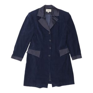 May include: A dark navy blue long-line blazer featuring a notched lapel collar with a smooth satin-like finish. The garment includes four matching fabric-covered buttons down the front, two side pockets with satin flaps, and satin cuffs.