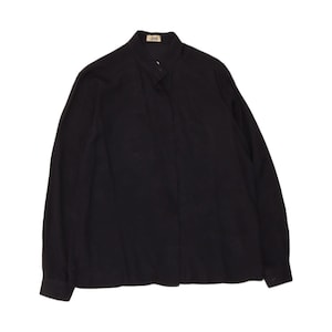 May include: A solid black long-sleeve shirt featuring a mandarin collar and a concealed button placket. The garment includes a small rectangular label at the inner neckline with the text 'Axel' printed in a dark font on a light background.