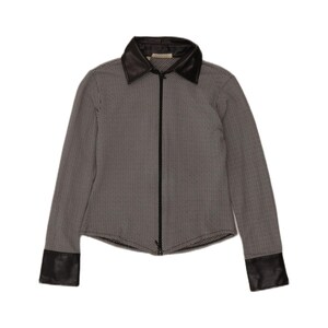 May include: A long-sleeved zip-up jacket featuring a black and white herringbone pattern. The garment includes a solid black collar and matching black cuffs at the end of each sleeve. A thin black zip runs vertically down the centre front.