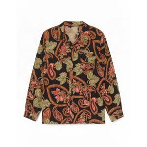 May include: A long-sleeved button-down shirt in black featuring a repeating pattern of orange and red paisley shapes intertwined with light green leaves and floral motifs. The shirt includes a standard collar, a front button placket, and a chest pocket.