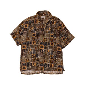 May include: A short-sleeved shirt featuring a quarter-zip collar and a repeating geometric pattern in shades of brown, black and tan. The fabric displays various square motifs including stars, wavy lines and abstract shapes across the entire garment.