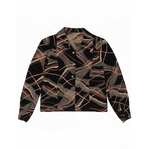 May include: A long-sleeved button-down shirt in black featuring a repeating abstract pattern of wavy, intersecting lines in shades of tan, cream, and muted red. The garment has a classic collar, a straight hem, and five visible buttons down the front.