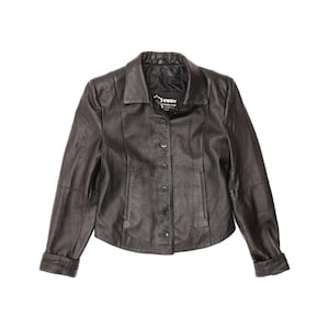 May include: A dark brown leather jacket featuring a classic collar, long sleeves with cuffs, and a front button closure. The interior label displays the text "EWRY". The jacket has a structured fit with visible seam detailing along the front panels.