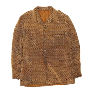 May include: A long-sleeve jacket in a golden brown and black geometric woven pattern. The jacket features a pointed collar, a central button-down front with four visible buttons, two chest pockets with button flaps, and two lower pockets.