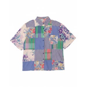 May include: A patchwork button-down shirt with a variety of floral, gingham, and solid fabric squares in shades of blue, green, pink, and purple. The short-sleeved shirt has a collared neckline and a single pocket.