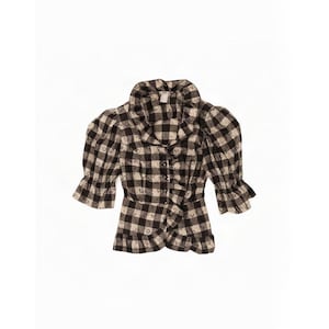 May include: A black and cream gingham print blouse featuring a ruffled collar, a front button closure, and short puff sleeves with ruffled cuffs. The garment has a peplum-style hem with a ruffled edge, creating a structured and layered appearance.