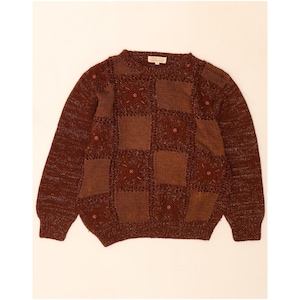 May include: A long-sleeved crew neck jumper in shades of brown, featuring a patchwork design of solid knit squares and open-work squares with floral motifs. The garment is accented with small red beads throughout the front panel.