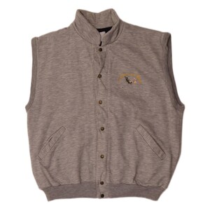 May include: A heather gray sleeveless vest featuring a mock neck collar, a front button-down closure with metallic snaps, and two slanted side pockets. An embroidered graphic of a scuba diver is positioned on the upper left chest area.