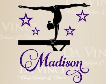 May include: A purple and black vinyl wall decal featuring a gymnast performing a handstand on a balance beam. The decal includes the name "Madison" in a decorative script font and four white stars.