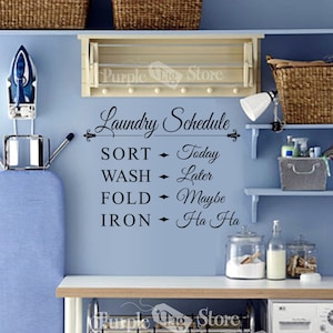 May include: A black and white laundry schedule wall decal with the text "Laundry Schedule" and a list of tasks: Sort, Wash, Fold, Iron. Each task is followed by a humorous description: Today, Later, Maybe, Ha Ha.