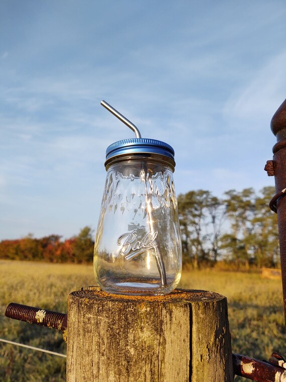 Glass drinking jar with lid and straw