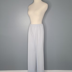 May include: Light blue wide-leg pants on a white mannequin against a gray background.