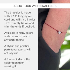 a woman wearing a bracelet with a heart on it