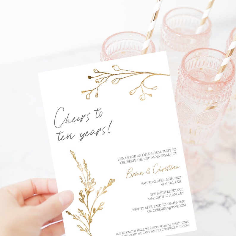 May include: A gold foil invitation with a floral design and the text "Cheers to ten years!"  Join us for an open house party to celebrate the 10th anniversary of Brian & Christina. Saturday, April 30th, 2023, 6pm till late. The Smith Residence, 12345 211th St Langley. RSVP by April 22nd to 123-456-7890 or Christina@rsvp.com. Due to limited space, we kindly request adults only. We can't wait to celebrate with you!