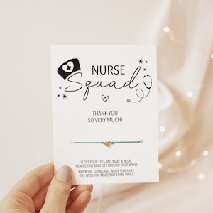 May include: A teal blue friendship bracelet with a gold heart charm. The card attached to the bracelet reads "NURSE Squad" with a stethoscope and nurse hat graphic. The card also says "Thank you so very much!" and includes instructions for making a wish.