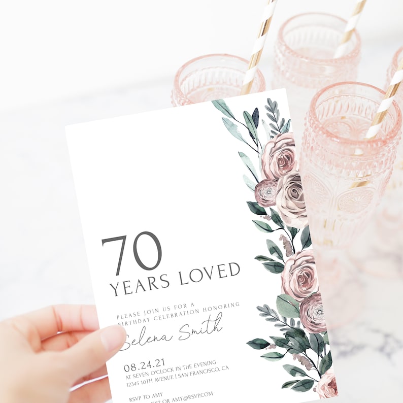 May include: A white invitation card with a floral design in shades of pink and green. The text on the card reads "70 Years Loved" and includes details for a birthday celebration honoring Selena Smith on August 24, 2021.