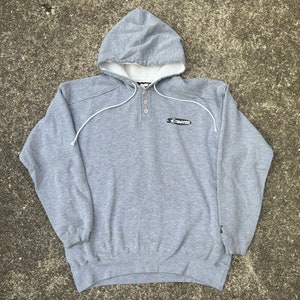 May include: Gray hooded sweatshirt with a button-up front and the word "Starter" printed on the chest.