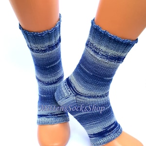 A pair of blue and white striped hand knit yoga socks with heel  with a light blue and white color gradient. The socks are made of a soft, comfortable sock yarn and are perfect for everyday wear. The socks are on a pair of mannequin feet.