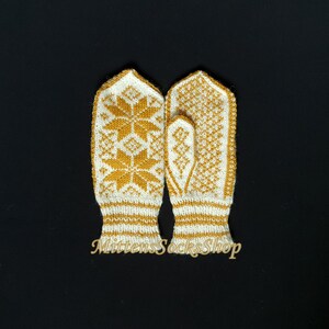 May include: A pair of white knitted mittens with a yellow snowflake pattern. The mittens have a ribbed cuff and are made of a soft, warm yarn.
