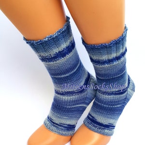 A pair of blue and white striped hand knit yoga socks with heel  with a light blue and white color gradient. The socks are made of a soft, comfortable sock yarn and are perfect for everyday wear. The socks are on a pair of mannequin feet. The socks are displayed on a white background.