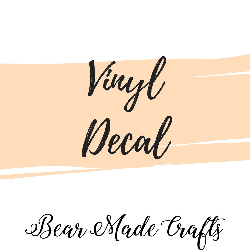 May include: A white background with a peach-colored horizontal brushstroke. The words "Vinyl Decal" are written in black script, with "Bear Made Crafts" in a similar script below.