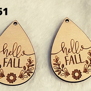 May include: Two wooden teardrop-shaped earrings with the text "hello fall" and a floral design.