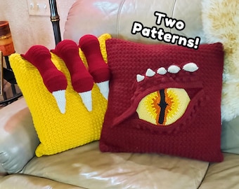 May include: Two square crochet pillows. One is yellow with three red and white claw-like appendages. The other is dark red with a large, central eye design featuring a yellow iris, black pupil, and white scales. Text reads: Two Patterns!