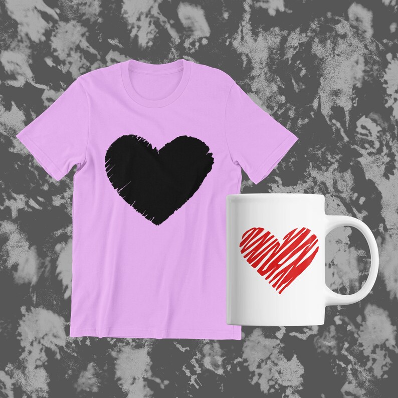 May include: A pink t-shirt with a black heart design and a white mug with a red heart design. The heart on the mug has a striped pattern.