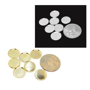 May include: Two sets of round metal tray blanks, one set is silver and the other is gold. The trays are about the size of a US quarter.