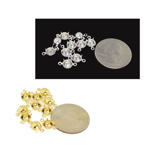 May include: A close-up of two groups of gold and silver bead caps. The bead caps are about the size of a US quarter. The bead caps have three loops on the back for attaching to jewelry.