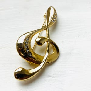 Générique Broche Bijou Acier doré clé de Sol et Micro Microphone
