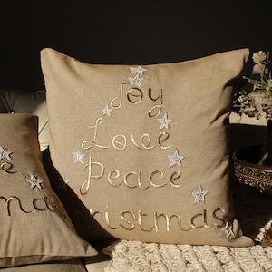 hand-embroidered christmas text single pillow in cotton chambray fabric