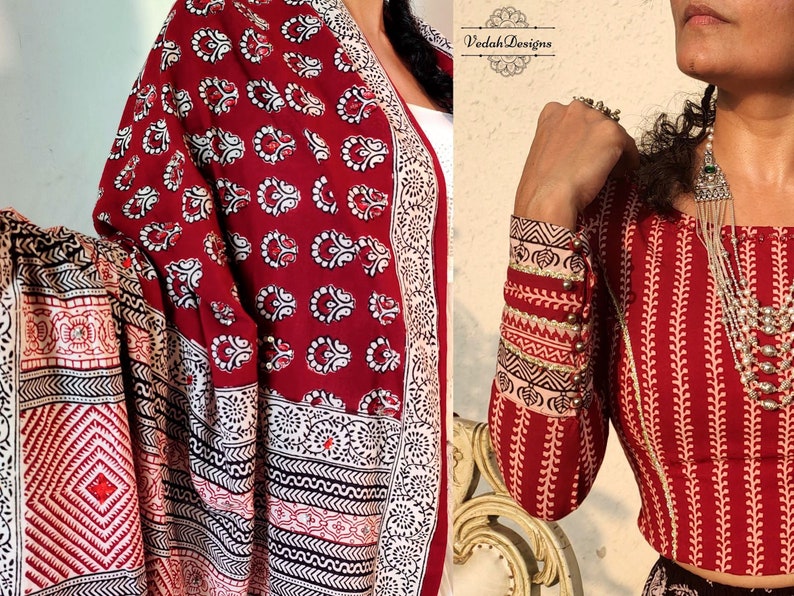 Puede incluir: Textil estampado en rojo y blanco con un patr&oacute;n floral repetido. Se ven las mangas de una blusa estampada en rojo y blanco. La blusa tiene un patr&oacute;n de hojas verticales y est&aacute; adornada con botones dorados.