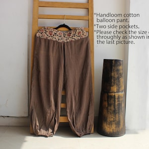May include: Brown cotton balloon trousers featuring a floral patterned waistband and two side pockets. The text on the image reads: Handloom cotton balloon pant. Two side pockets. Please check the size chart throughly as shown in the last picture.