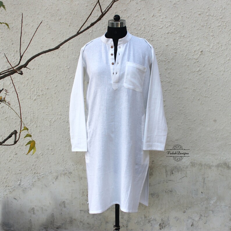 May include: White long-sleeved shirt with a button-up collar and a single pocket on the left side. The shirt is made of a lightweight fabric and has a relaxed fit.