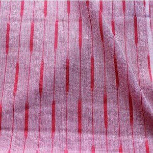 May include: A piece of woven fabric featuring a light pink base with a repeating pattern of vertical red stripes. The stripes are composed of elongated, dashed segments that create a textured appearance across the surface of the textile material.