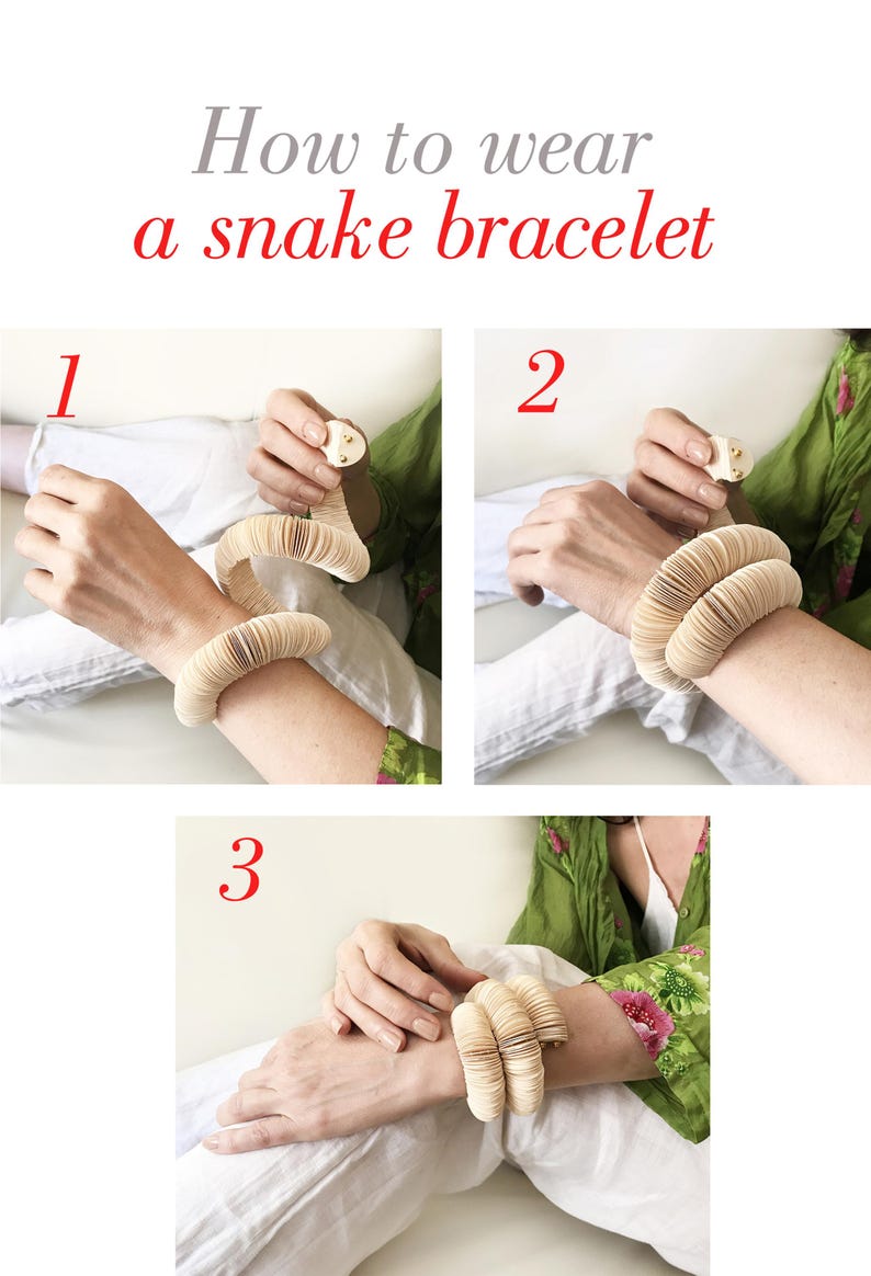 May include: A three-step guide on how to wear a snake bracelet. The bracelet is made of stacked, light-colored, rounded segments. The text "How to wear a snake bracelet" is in gray and red.