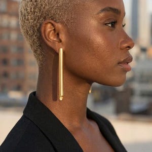 Large gold plated tube statement earrings with sterling silver studs for a modern minimalist look