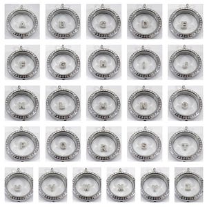 May include: Twenty-six silver locket pendants with clear glass inserts and crystal accents. Each locket features a different letter of the alphabet.