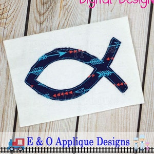 May include: A blue and white fish-shaped applique with a pattern of arrows and triangles. The applique is on a white background.
