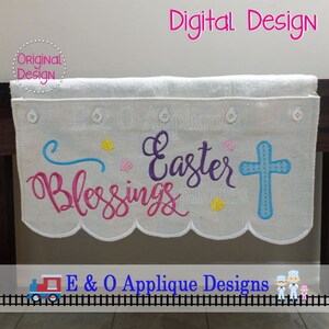 May include: Embroidered Easter banner with the words "Easter Blessings" in pink and purple lettering, a blue cross, and yellow seashells. The banner is white with a scalloped edge and is hanging on a wooden surface.